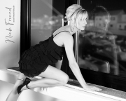 Junge blonde Frau blickt aus dem Fenster